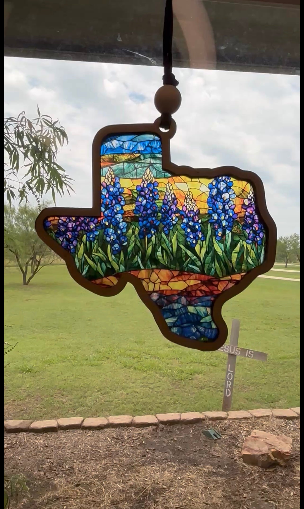 Texas-shaped suncatcher with rustic wood and vibrant multicolor acrylic in sunlight.