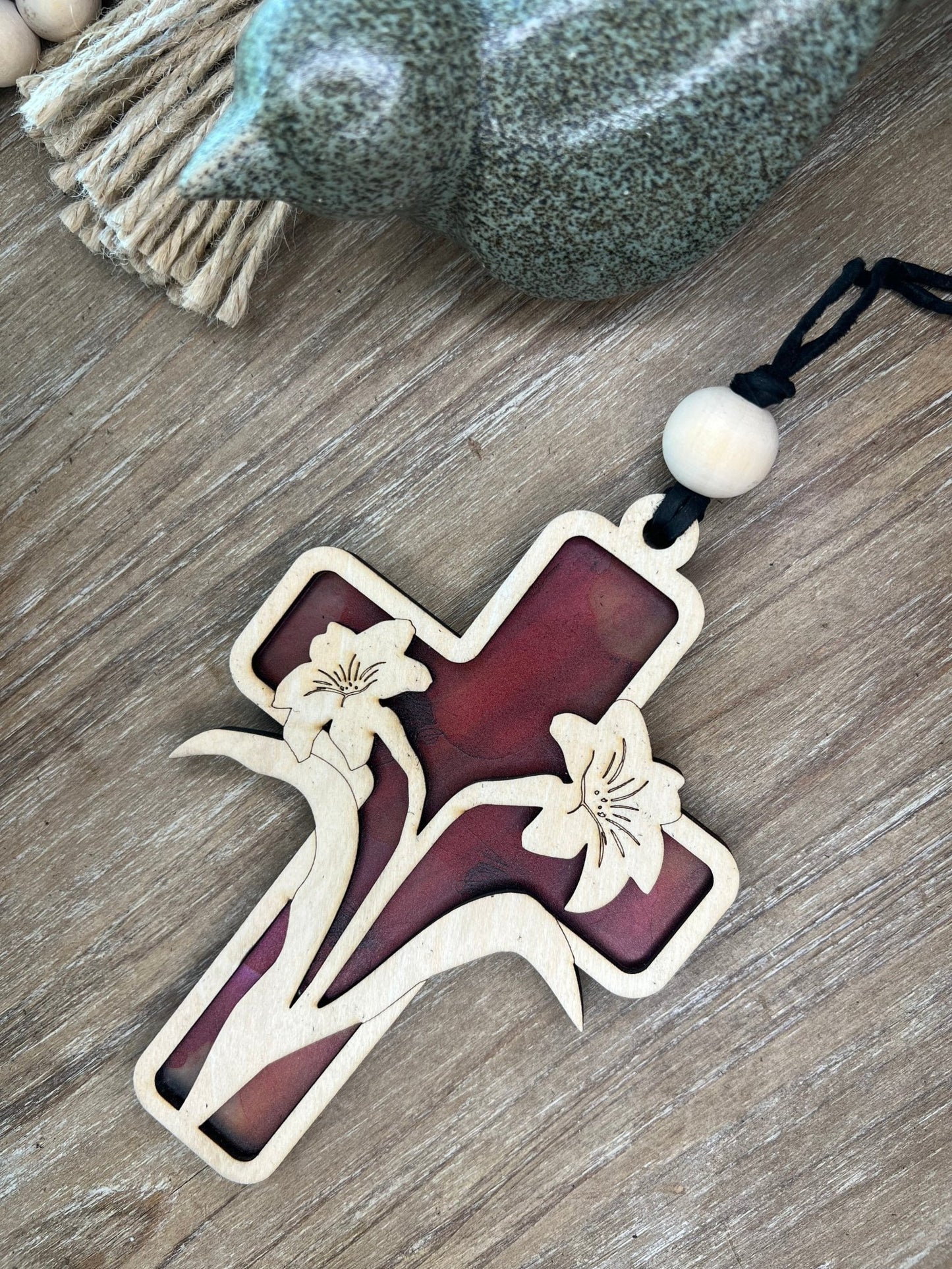 Lily Cross Suncatcher with a stained glass effect, crafted from colorful acrylic and wood.