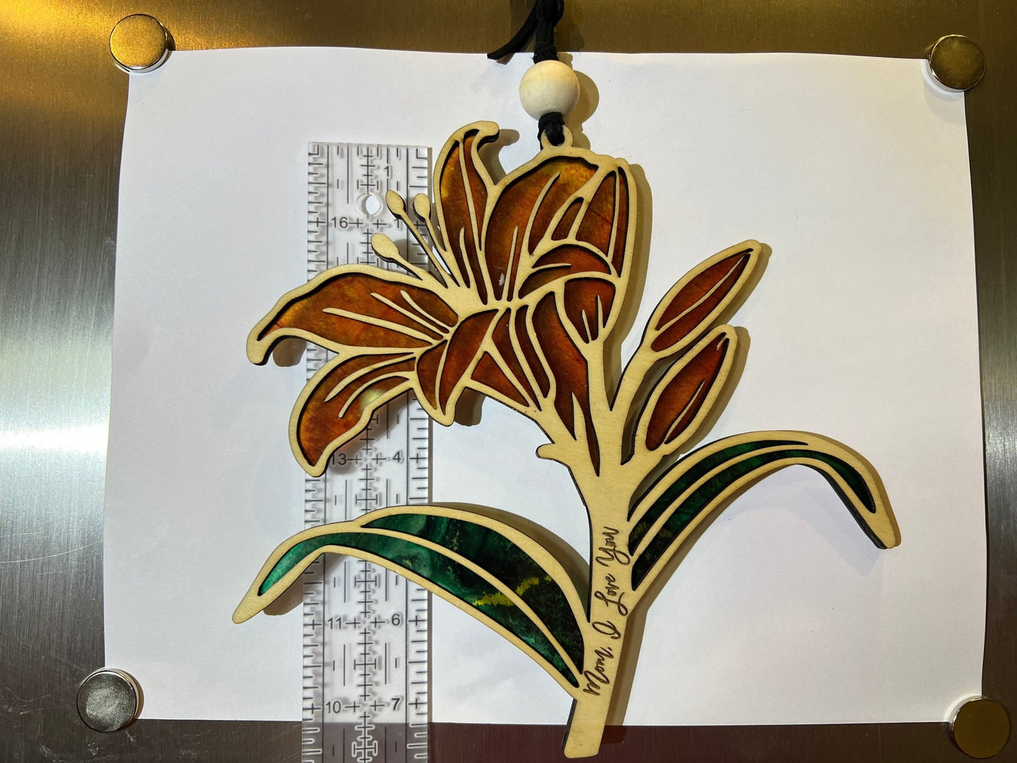 Orange Daylily stained glass effect suncatcher in wood and acrylic on white.