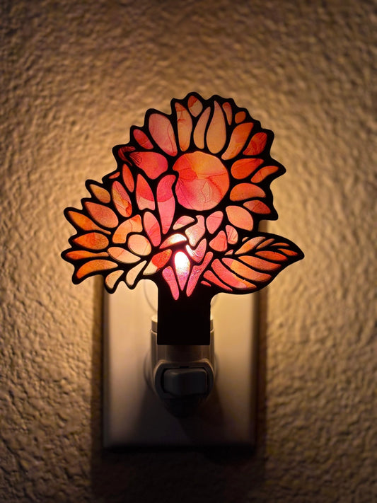 A charming nightlight with pink and coral flower design on wood and acrylic, offering a rustic-modern feel lighted.