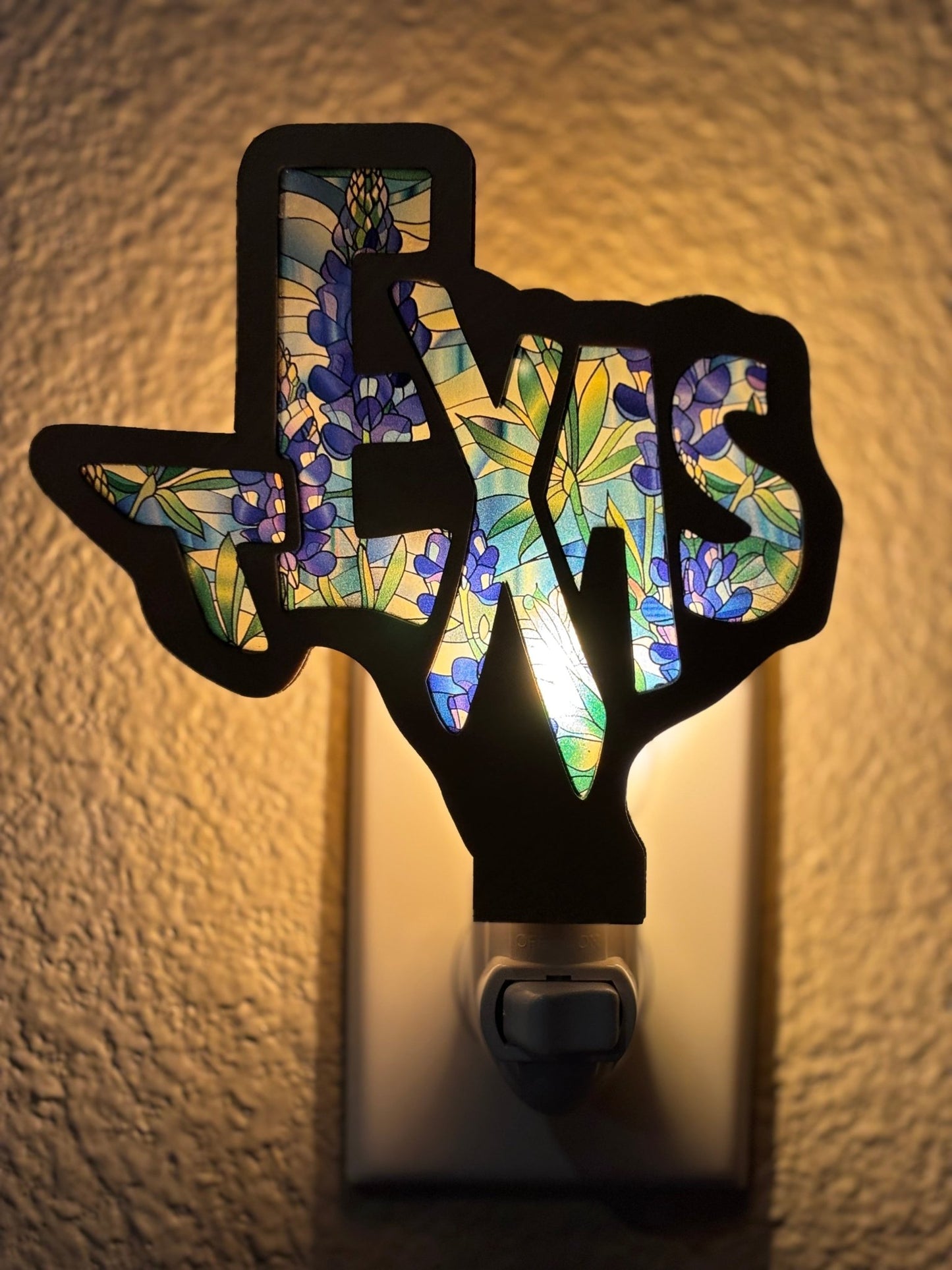 Texas-shaped nightlight featuring stained glass effect with wood and acrylic materials l;ighted.