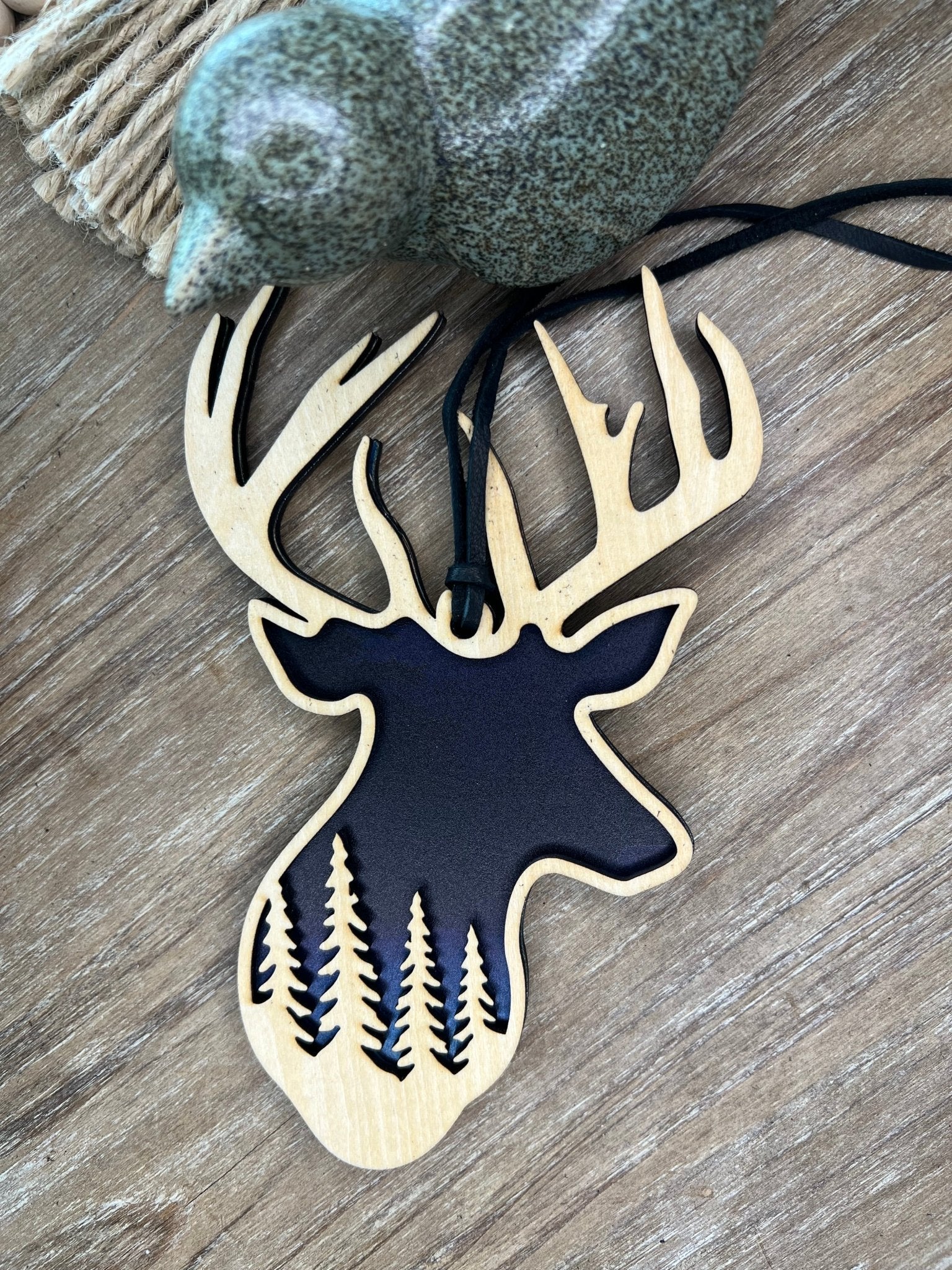 Handmade Buck Sky and Trees Suncatcher featuring natural wood and multicolor acrylic.