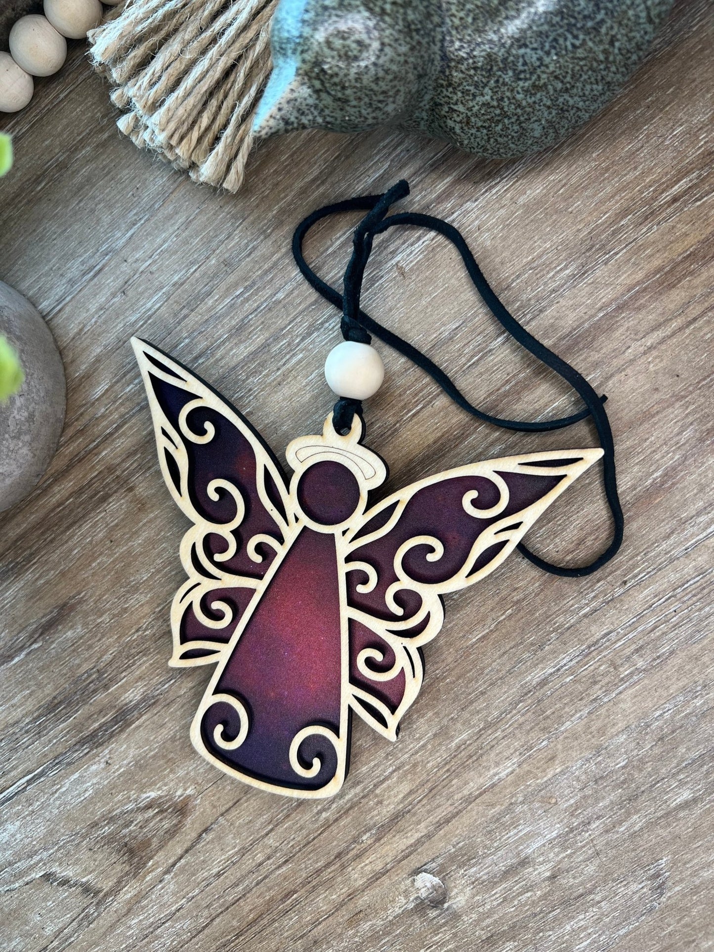 Angel suncatcher with natural wood and multicolor acrylic, hanging in sunlight.