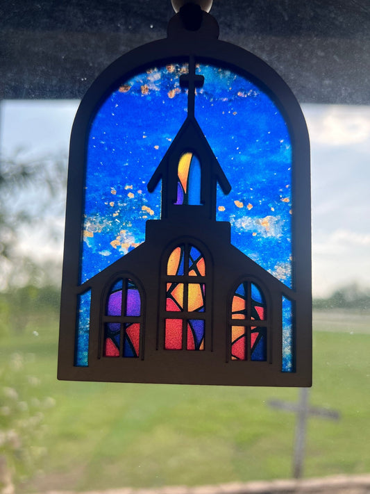 Colorful church suncatcher with stained glass effect, crafted from wood and acrylic in sunlight.