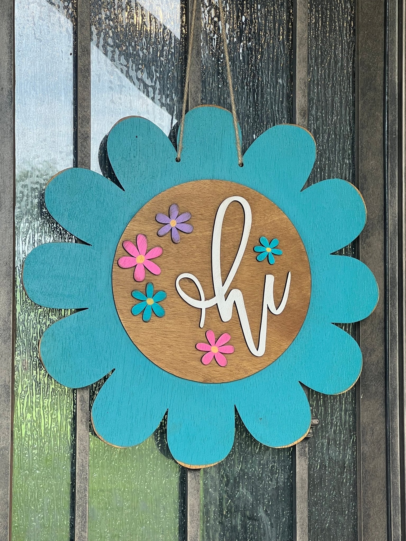 Turquoise flower door hanger made of natural wood with vibrant multicolor design on metal.