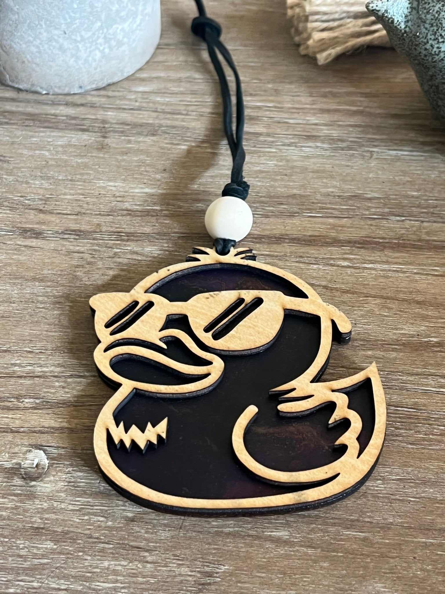 Colorful rubber duck suncatcher in wood and acrylic, rustic-modern decor.