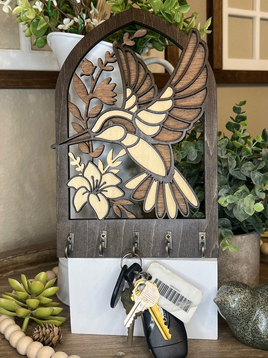 Laser-cut wooden key holder featuring a layered hummingbird and floral design with six hooks view from the bac — rustic home wall decor by Bear Necessity Designs.