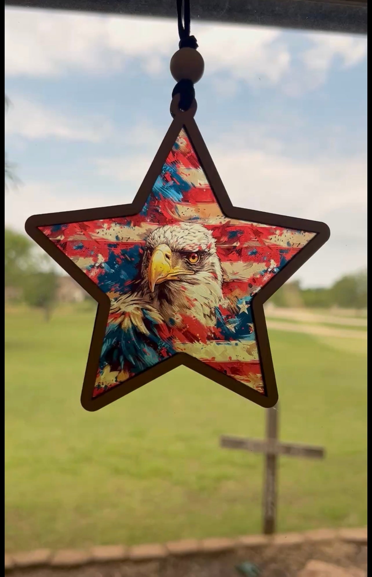 American Eagle star suncatcher with wood and multicolor acrylic, 5.5 inches in sunlight.