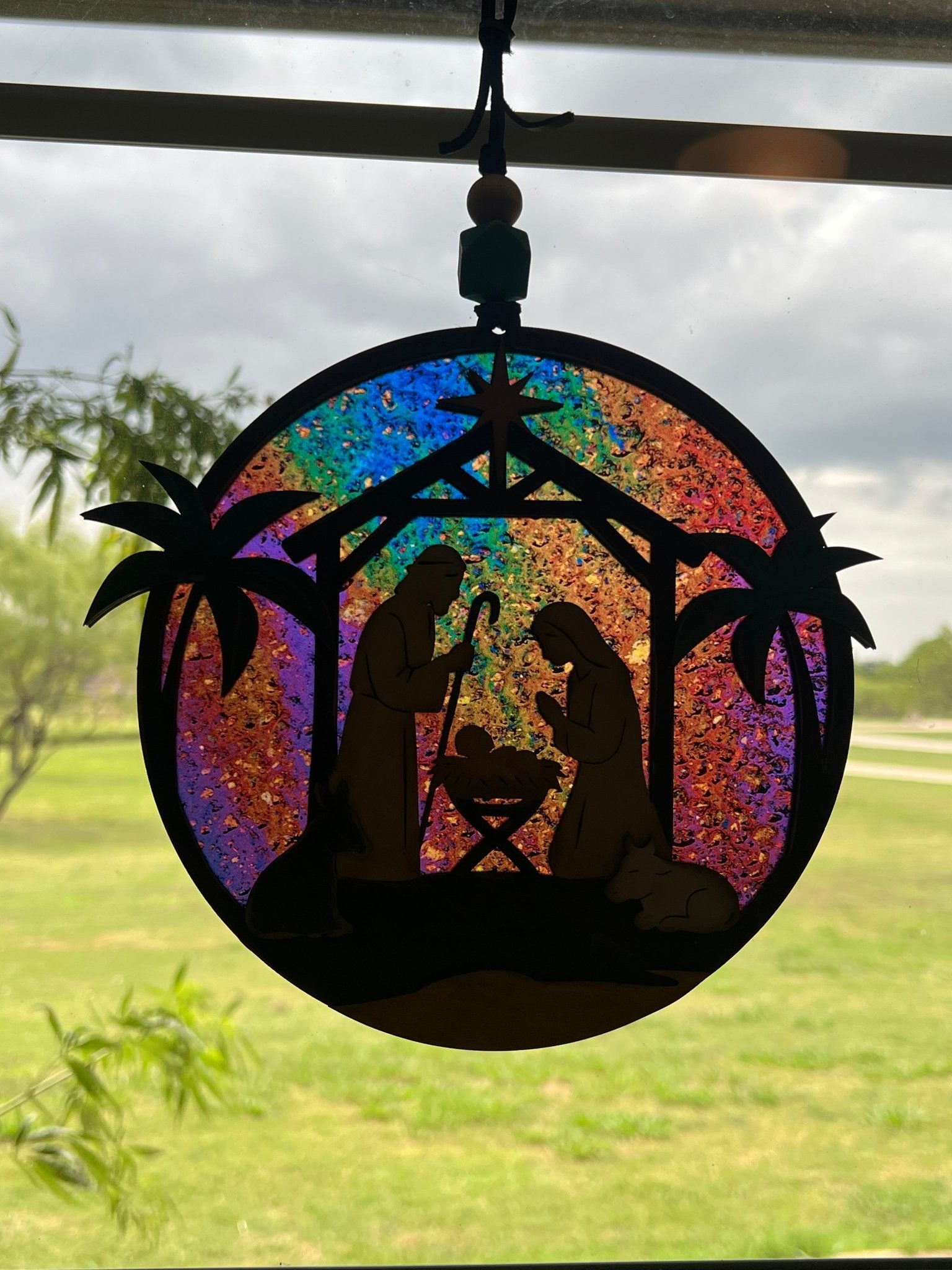 Haunted House Lantern Nightlight with stained glass effect in golden oak wood, perfect for rustic decor - in sunlight on a window.