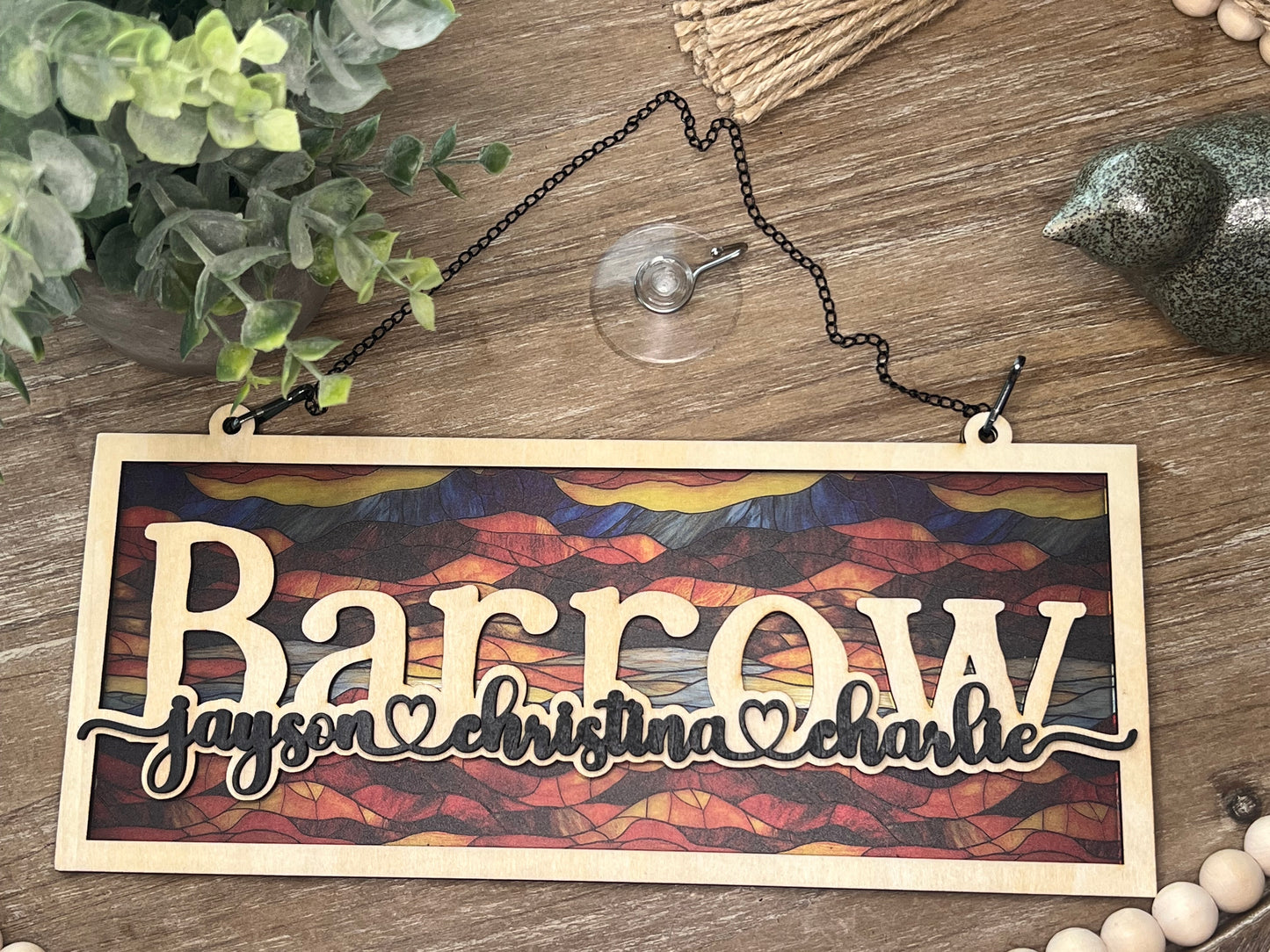 Family Personalized Suncatcher in natural wood and multicolor acrylic, showcasing rustic-modern style laying on tray.