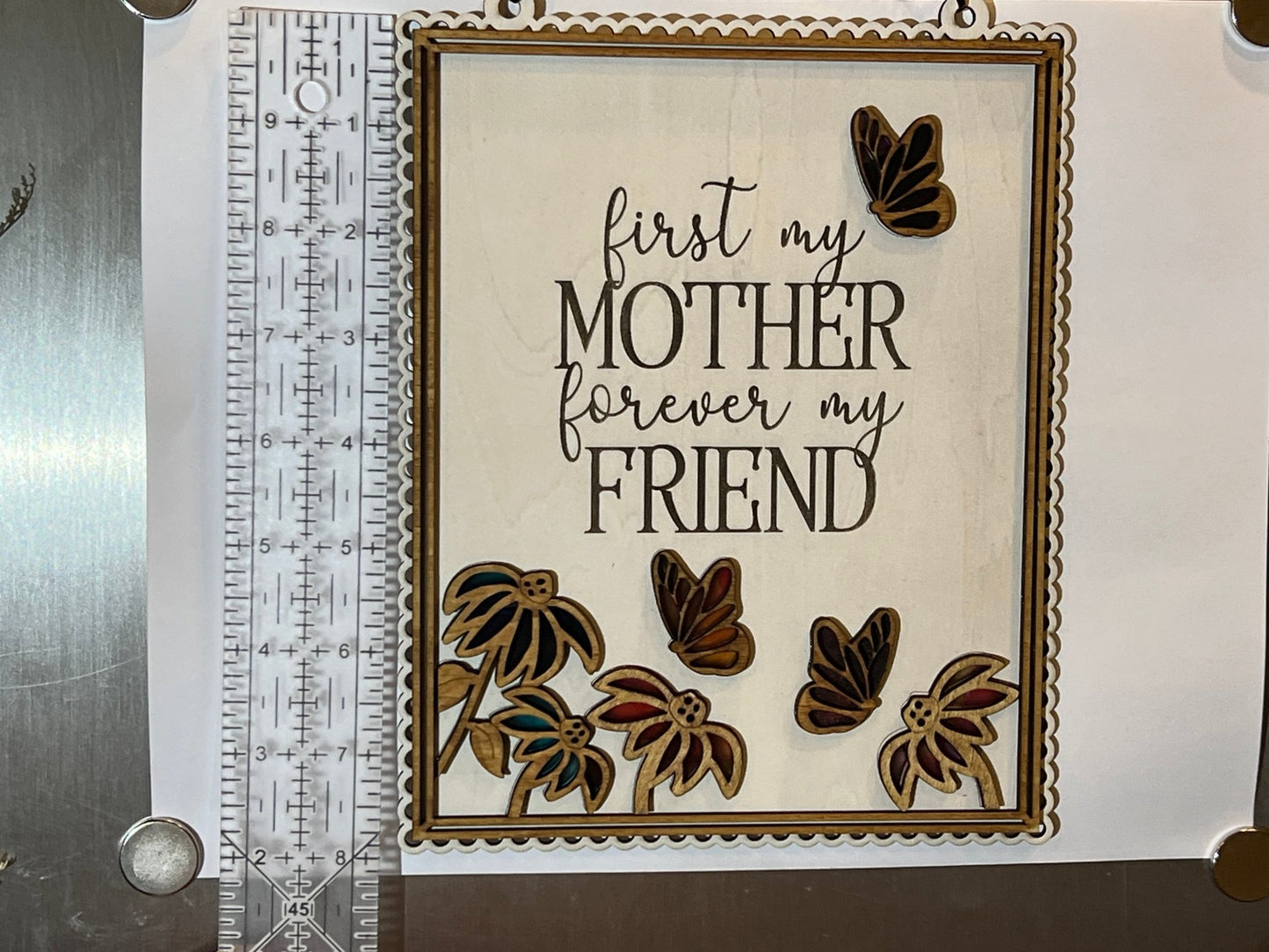 Colorful Mother Butterfly Suncatcher made of acrylic and wood, on a white background with ruler.