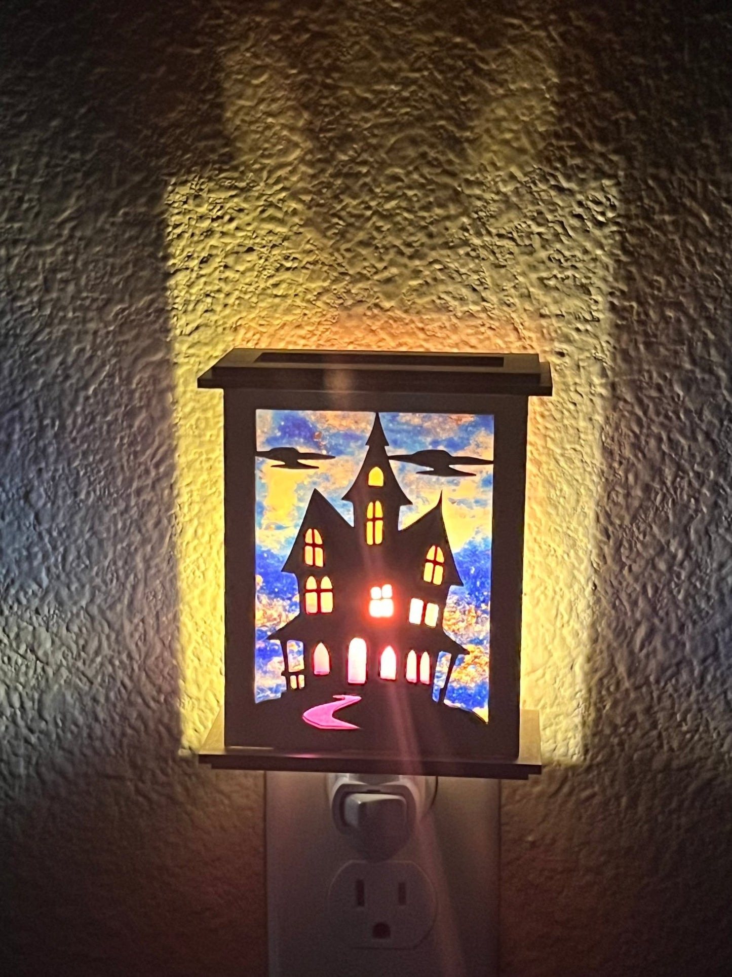 vHalloween Haunted House Lantern Nightlight made from wood and acrylic, showcasing rustic charm and multicolor glow lighted in hall front view.