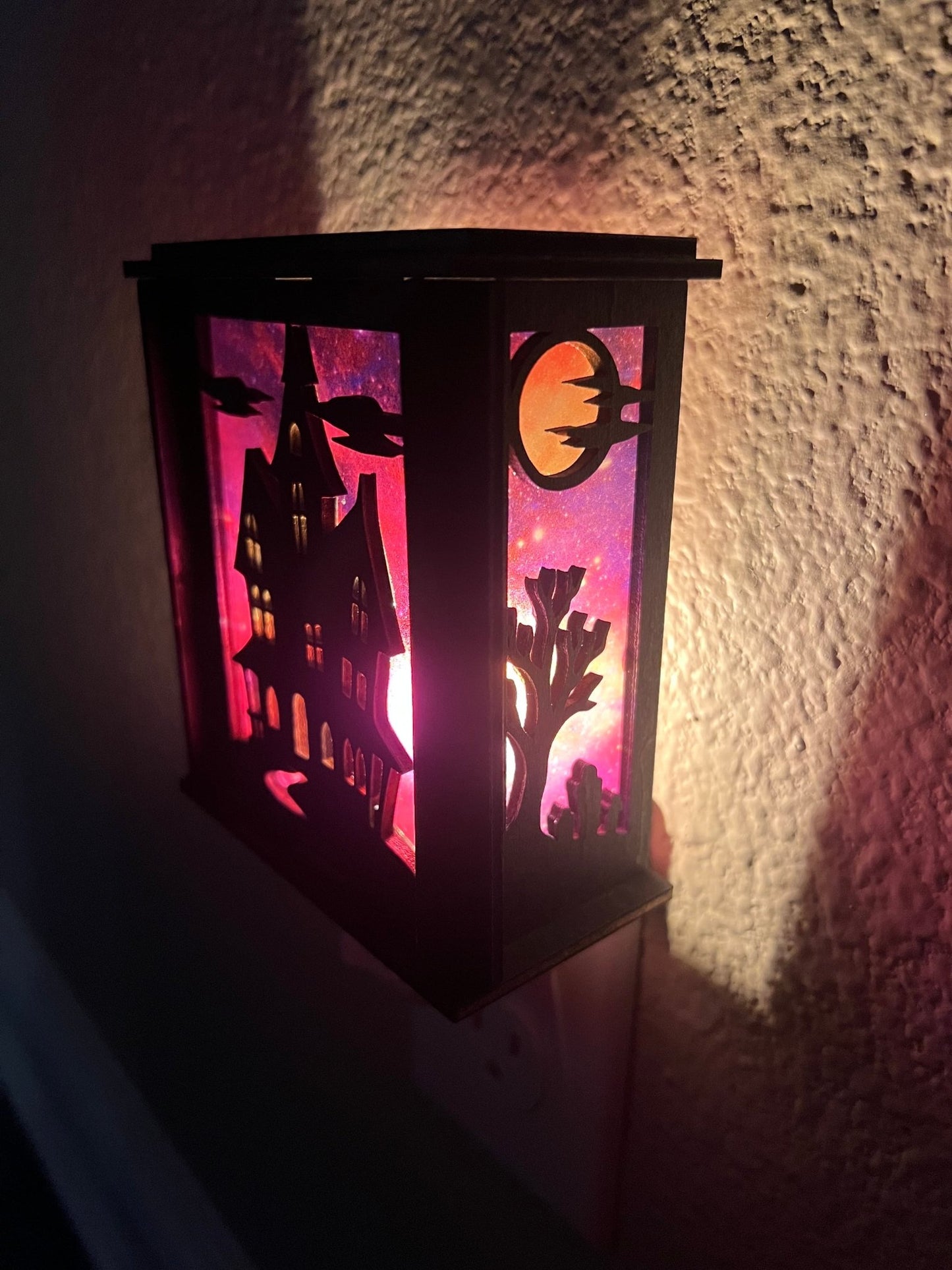 Black wooden haunted house nightlight with multicolor acrylic accents - right side lit.