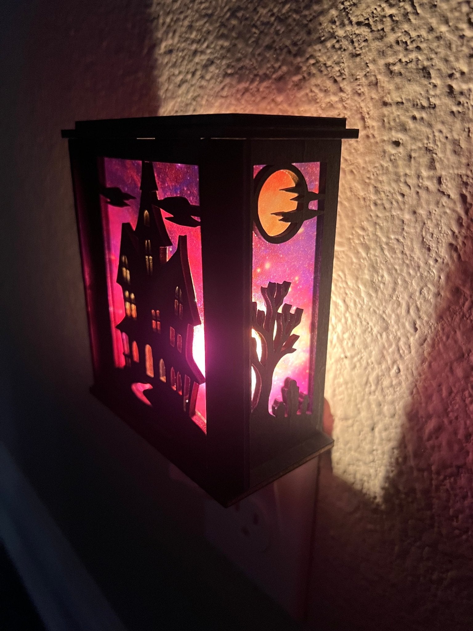 Black wooden haunted house nightlight with multicolor acrylic accents - right side lit.