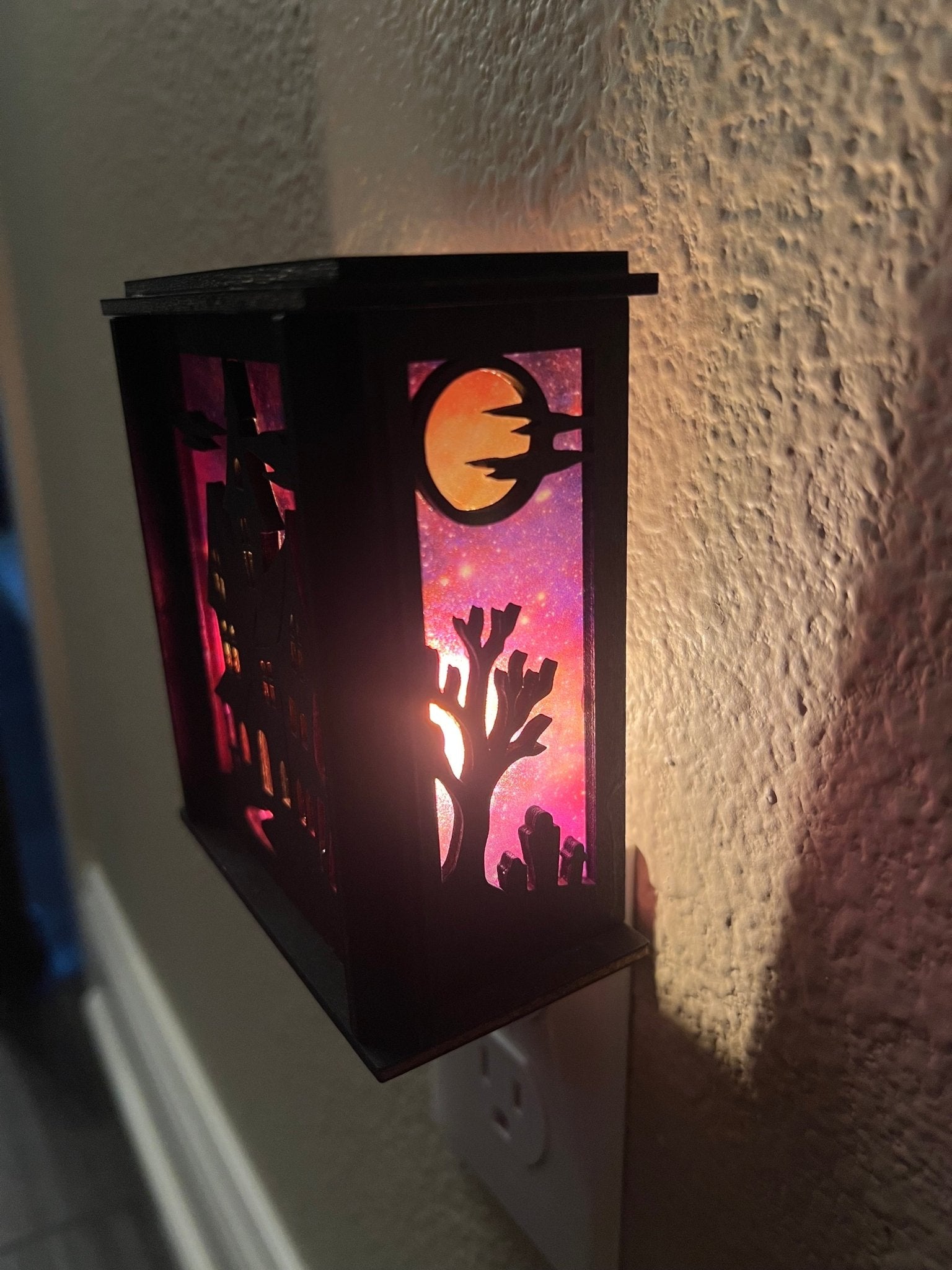 Black wooden haunted house nightlight with multicolor acrylic accents - right side lit.