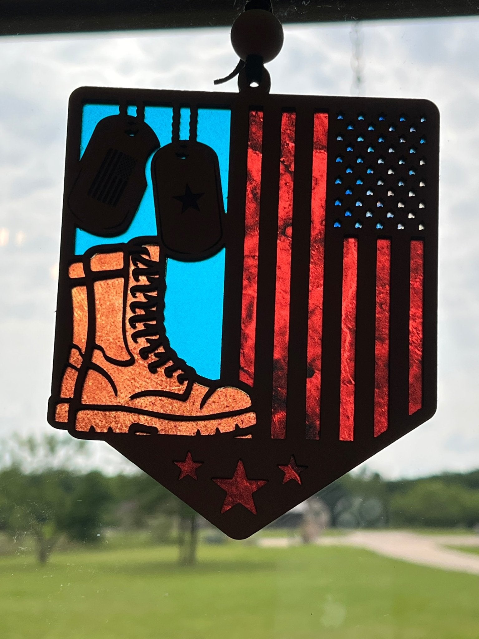 Multicolor stained glass effect suncatcher in sunshione in wood and acrylic, honoring soldiers.