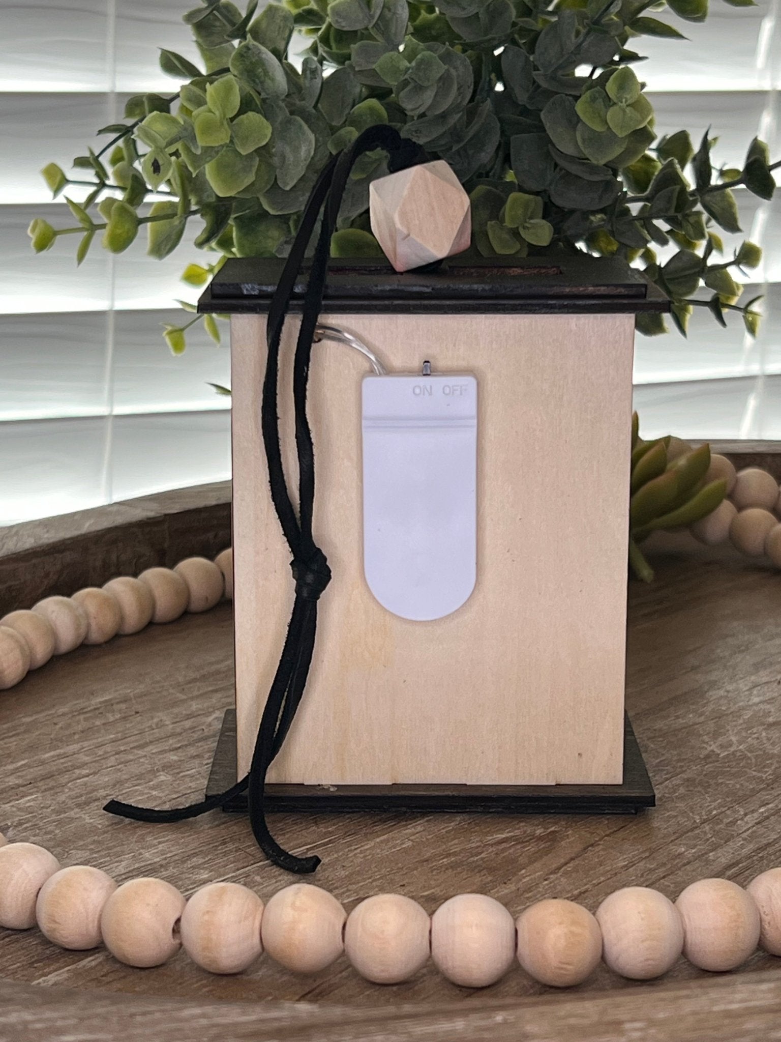 Lighted Christmas Nativity Lantern Ornament made with a natural and walnut stain and acrylic, back view.