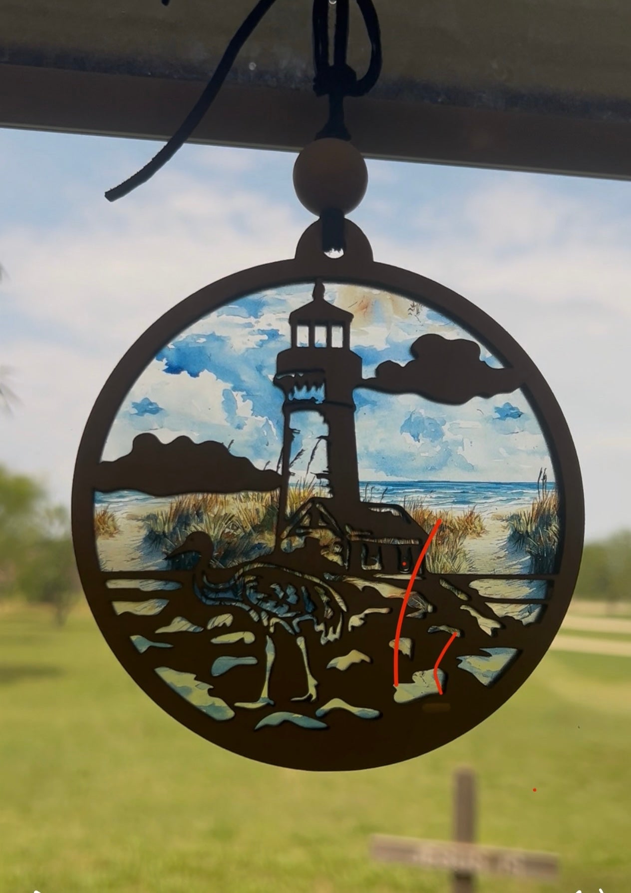 Lighthouse nightlight made of natural wood and multicolor acrylic, offering a rustic-modern feel in sunlight.