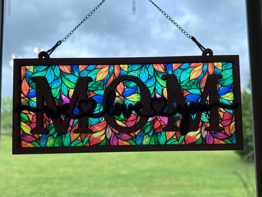 Beautiful mom suncatcher with pink floral design in wood and acrylic, 4.25 x 9.5 inches in sunlight