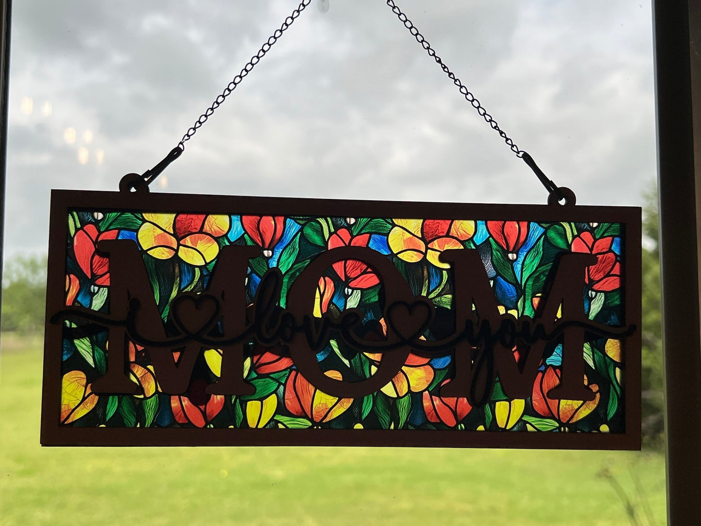 Yellow floral suncatcher with wood and acrylic, rustic charm, 4.25x9.5 inches in sunlight.