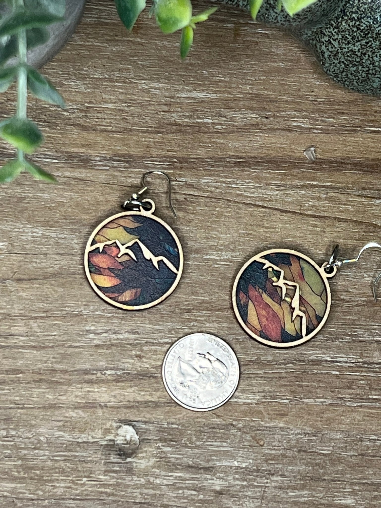 Handmade mountain suncatcher earrings with stained glass effect, featuring natural wood and multicolor acrylic.