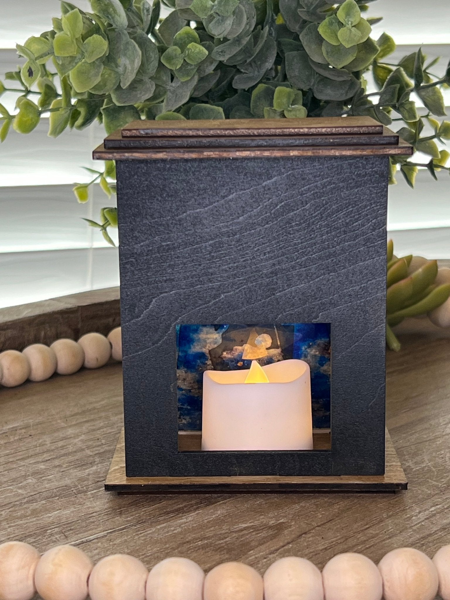 Rustic black and golden oak nativity lantern with LED tea-light candle, perfect for holiday decor, back, lit view
