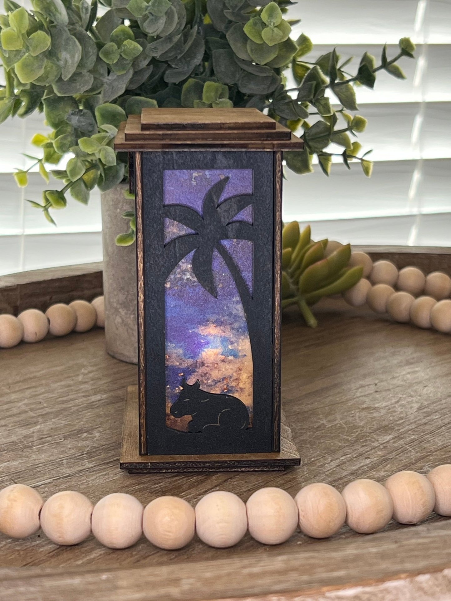 Rustic black and golden oak nativity lantern with LED tea-light candle, perfect for holiday decor, left side, lit view