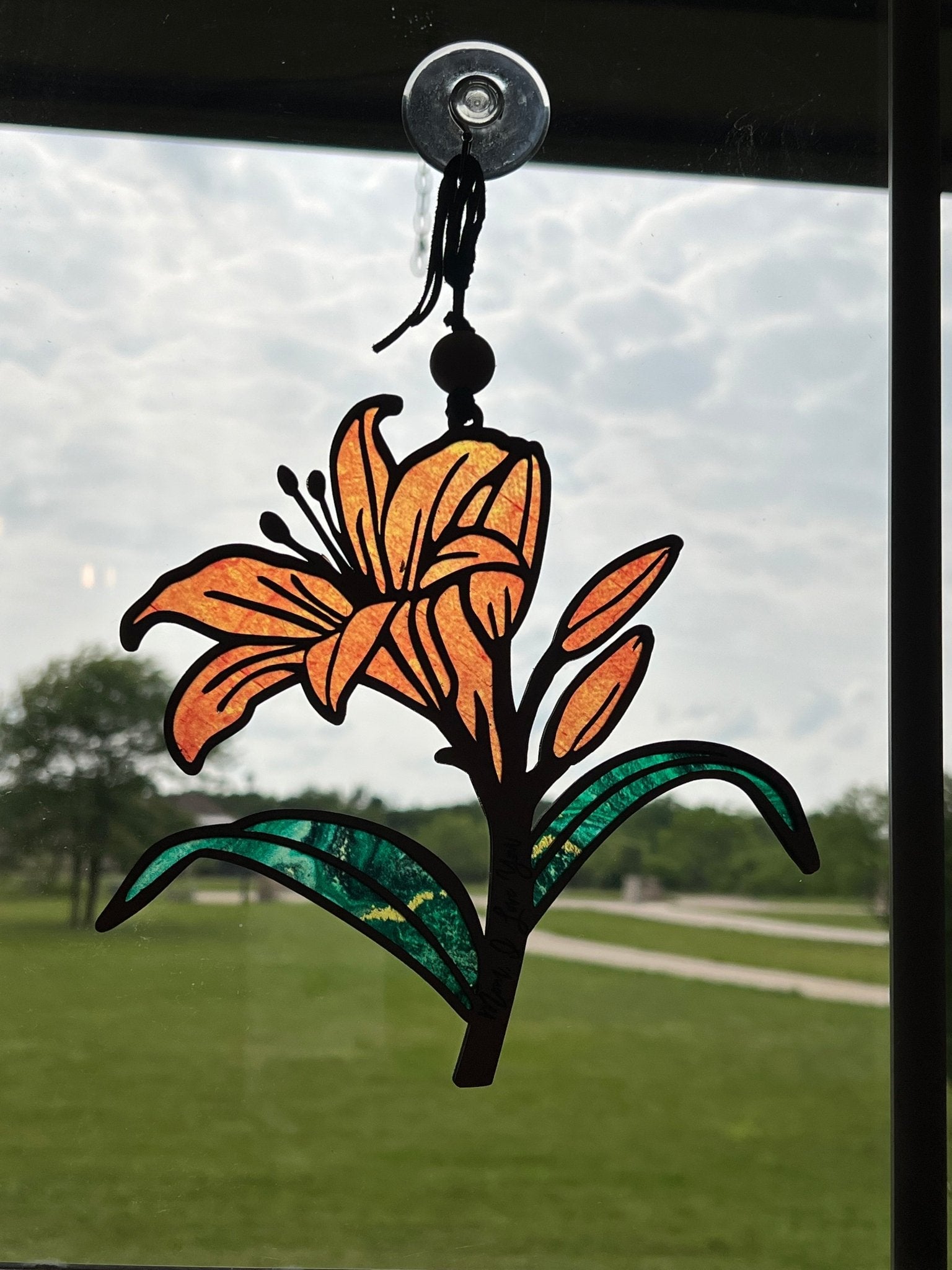 Orange Daylily stained glass effect suncatcher in wood and acrylic in sunshine.