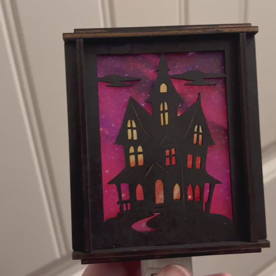 Black wooden haunted house nightlight with multicolor acrylic accents video unlit.