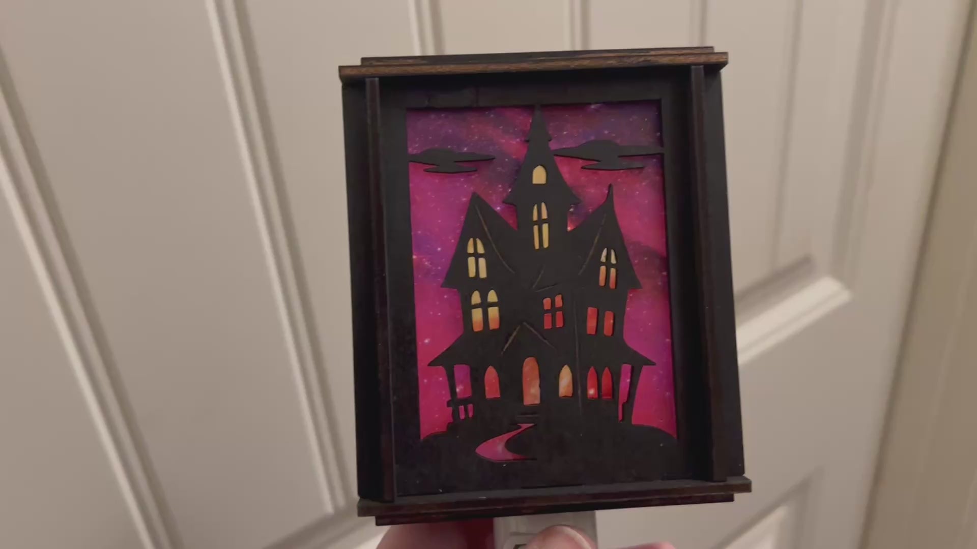 Black wooden haunted house nightlight with multicolor acrylic accents video unlit.