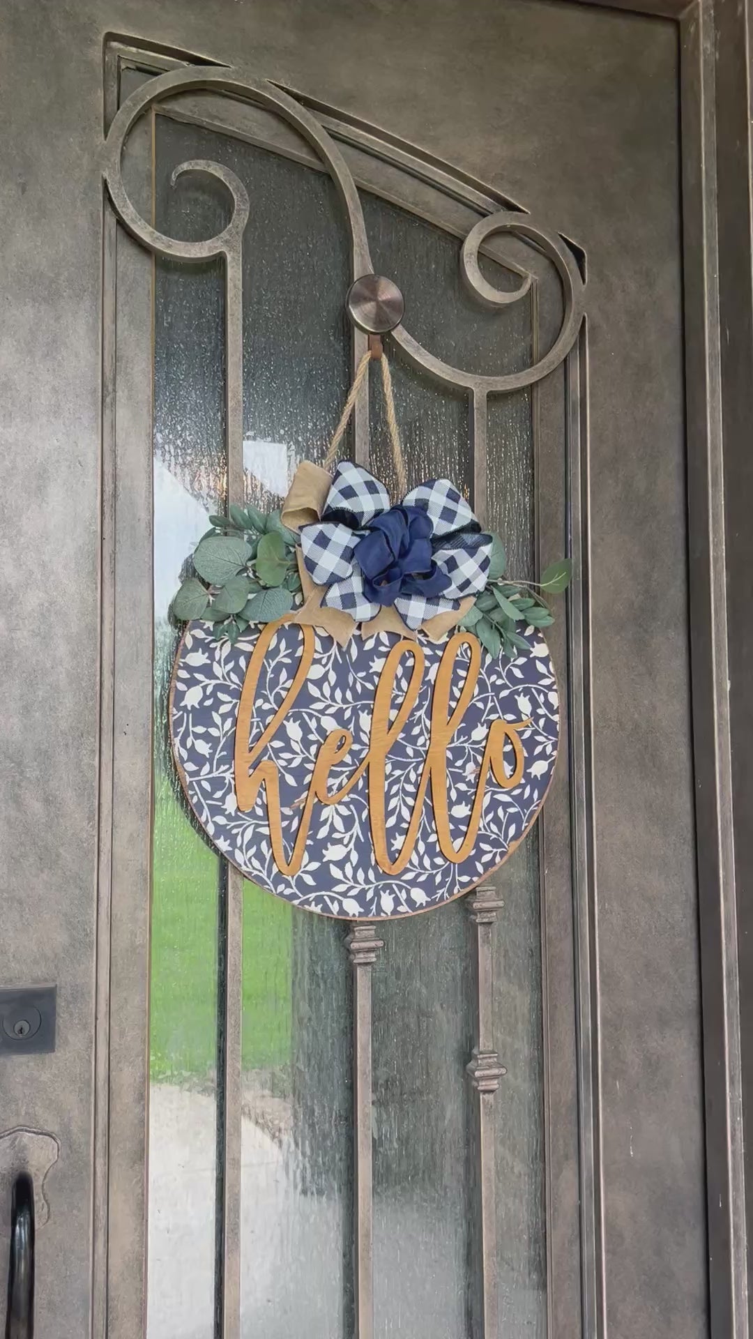Navy wood hello door hanger with mini flowers on metal door video, perfect for rustic entryway decor.