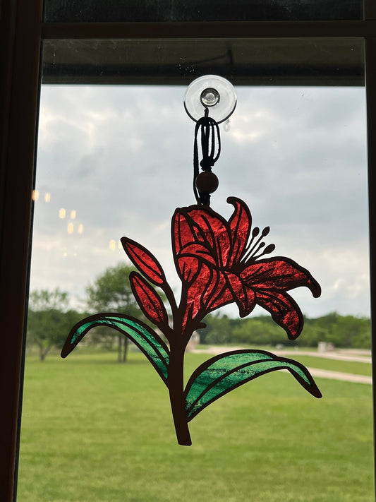 Red Daylily stained glass effect suncatcher with wood and acrylic materials, in sunshine, perfect for rustic home decor.
