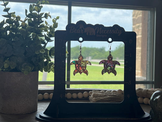 Turtle stained glass effect earrings made of wood and acrylic with a multicolor finish in sunlight.