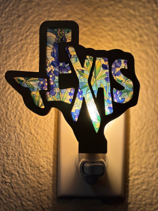 Texas-shaped nightlight featuring stained glass effect with wood and acrylic materials l;ighted.